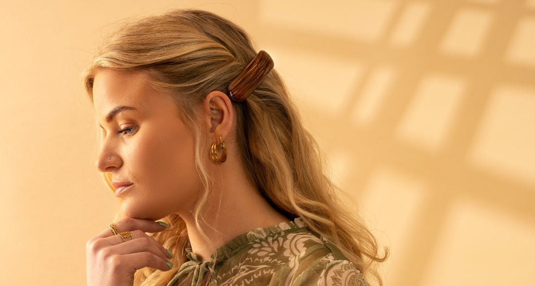 Woman wearing a hand painted TEGEN Coastal hair accessory