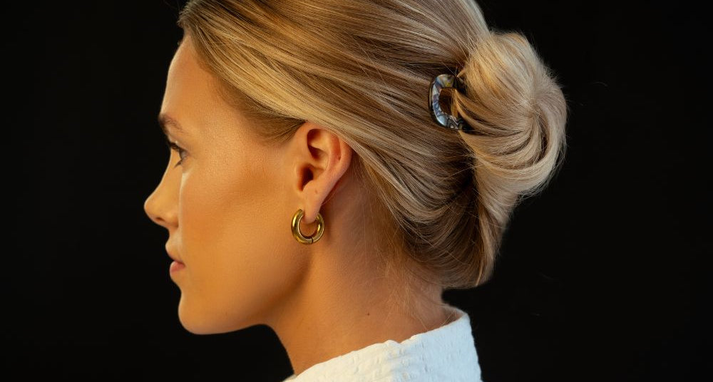 Woman with fine blonde hair in a low bun, side profile, by TEGEN